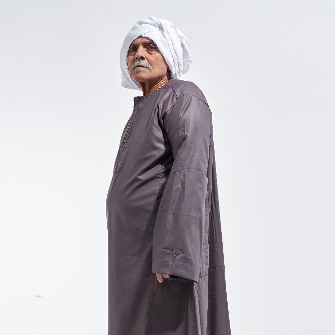 an old man wearing Galabia an isolated background
