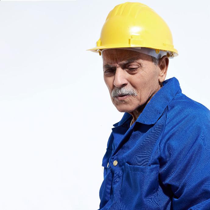 old Egyptian worker in a blue uniform on isolated background. The 1st of May is labor day.