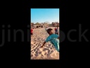 boys playing football on a beach