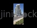 car traffic in front of high glass tower in alamein