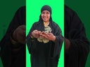 Video of a girl-Saidi girl holding an upper Egyptian accessories earring in her hand and looking in front of her and smiling.