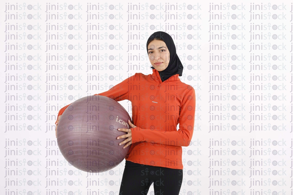 Woman working out with a rubber ball stock image on isolated image