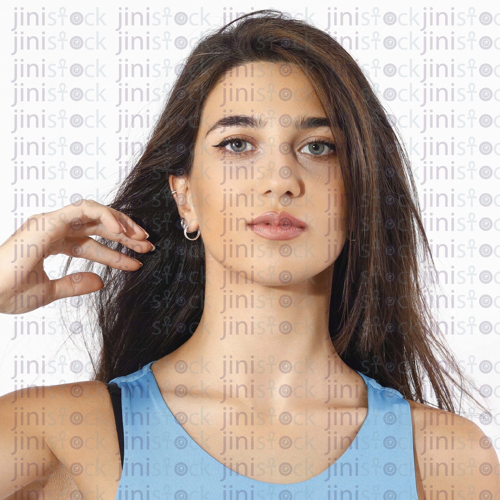 Portrait of a beautiful woman with a long hair. Young brunette model with beautiful hair - isolated on white background. Young girl with hair flying in the wind.