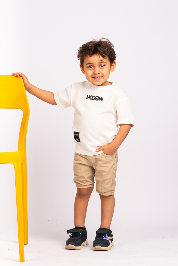 happy boy with hands in his pockets - stock image