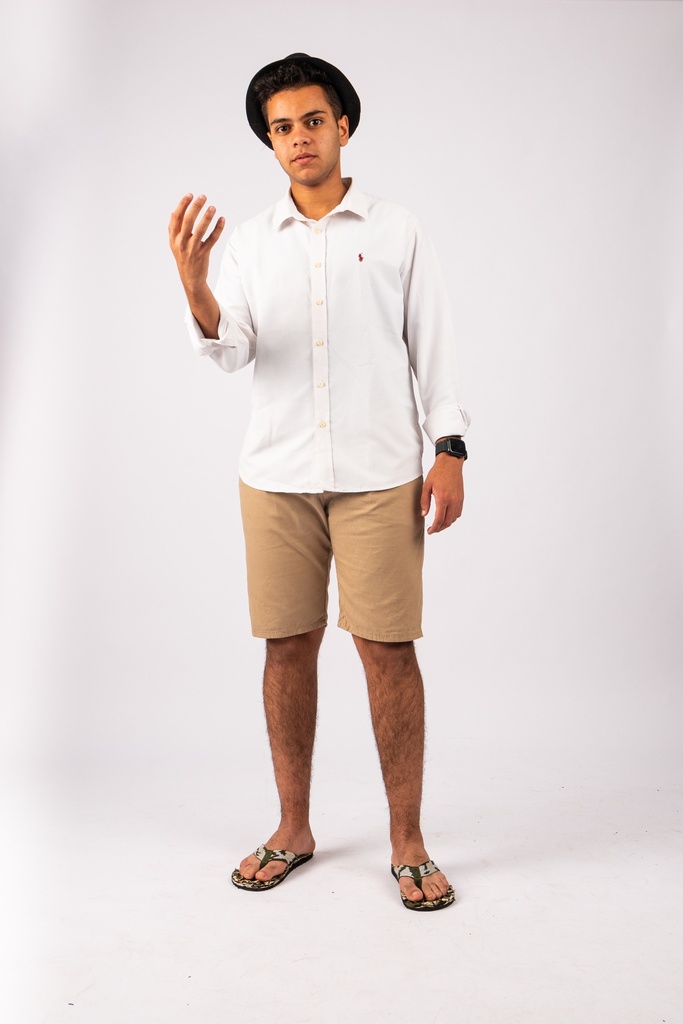 young man wearing a hat and holding someting in his hand - stock image