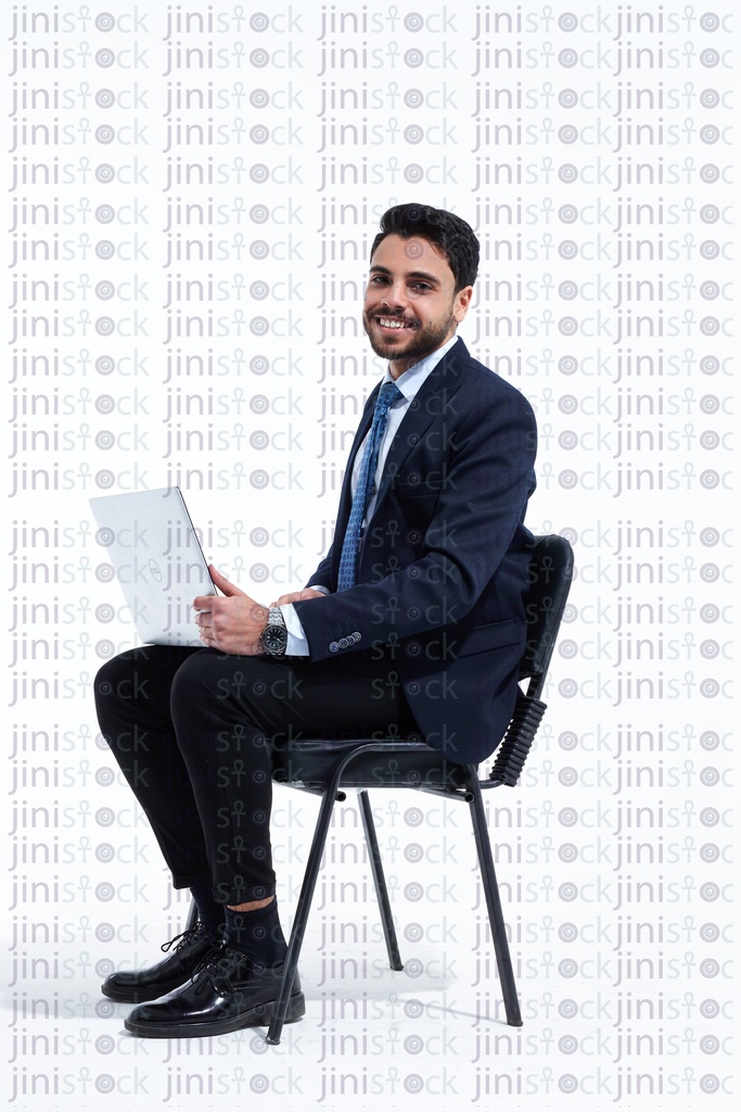 man in a business suite employee happy working on laptop