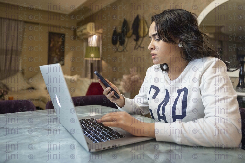 woman working from home and trying to multi task