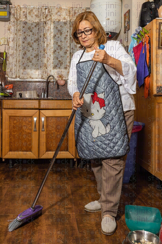 old Egyptian woman cleaning the kitchen