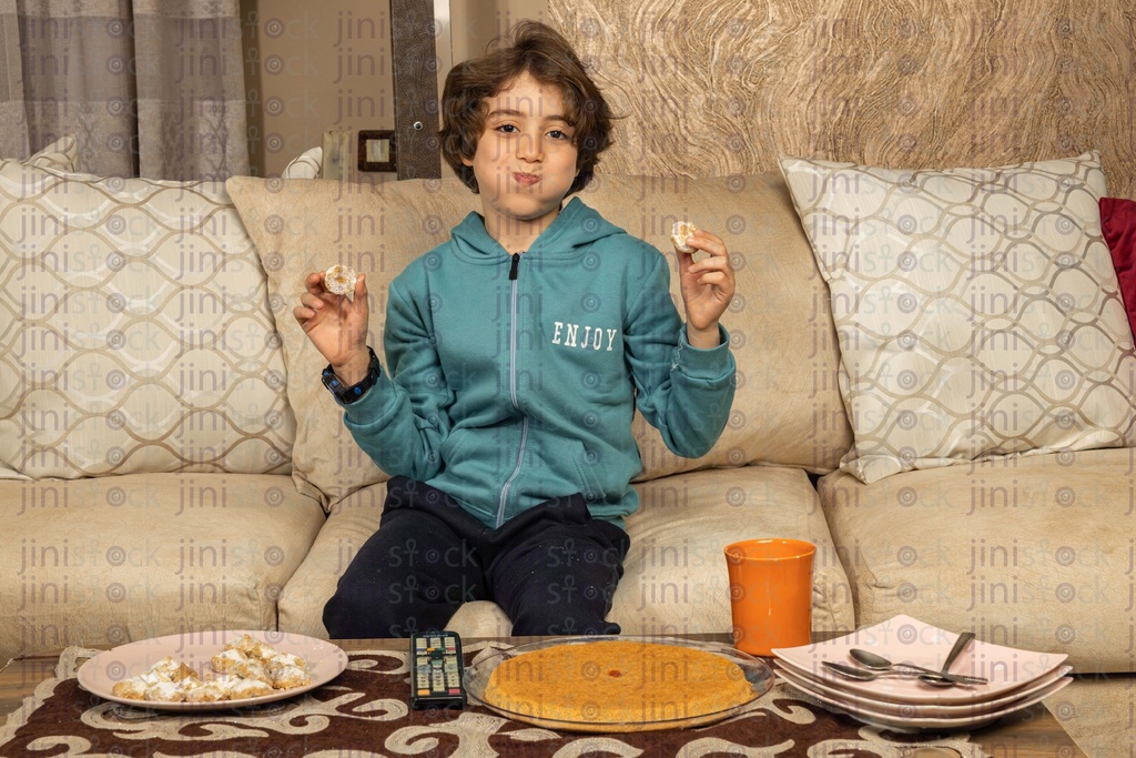 boy eating sweets and khak el eid