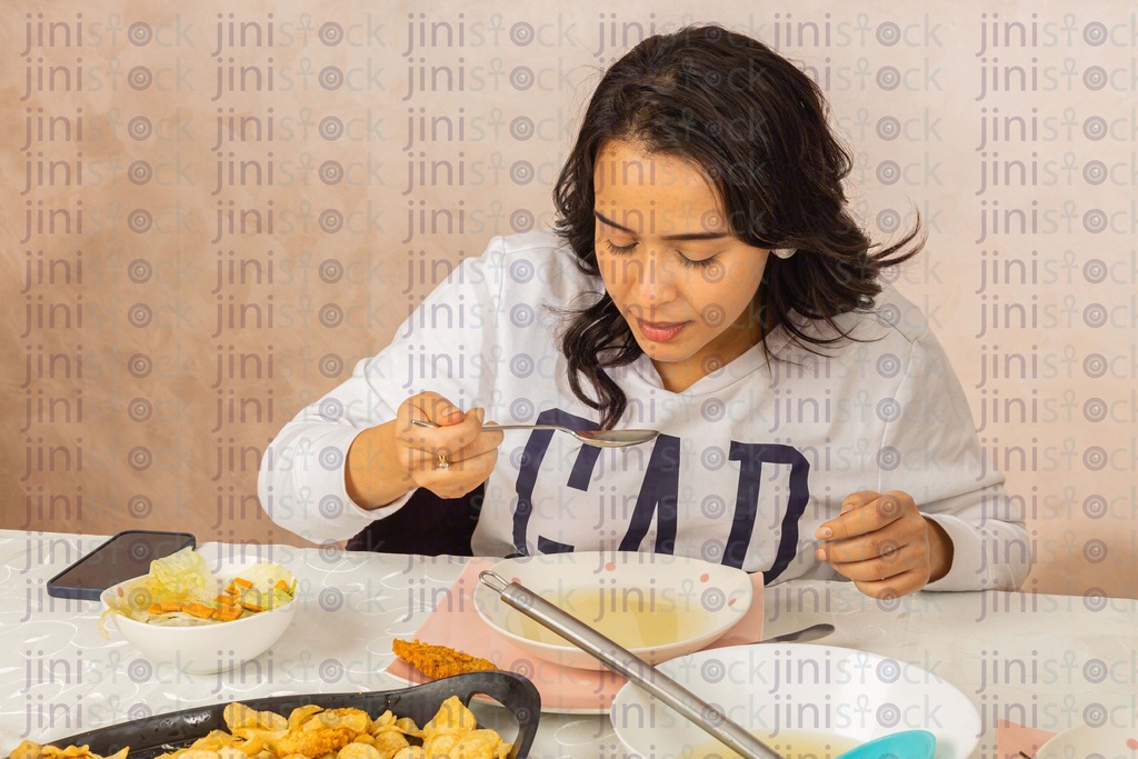 Egyptian woman eating on a dinning table