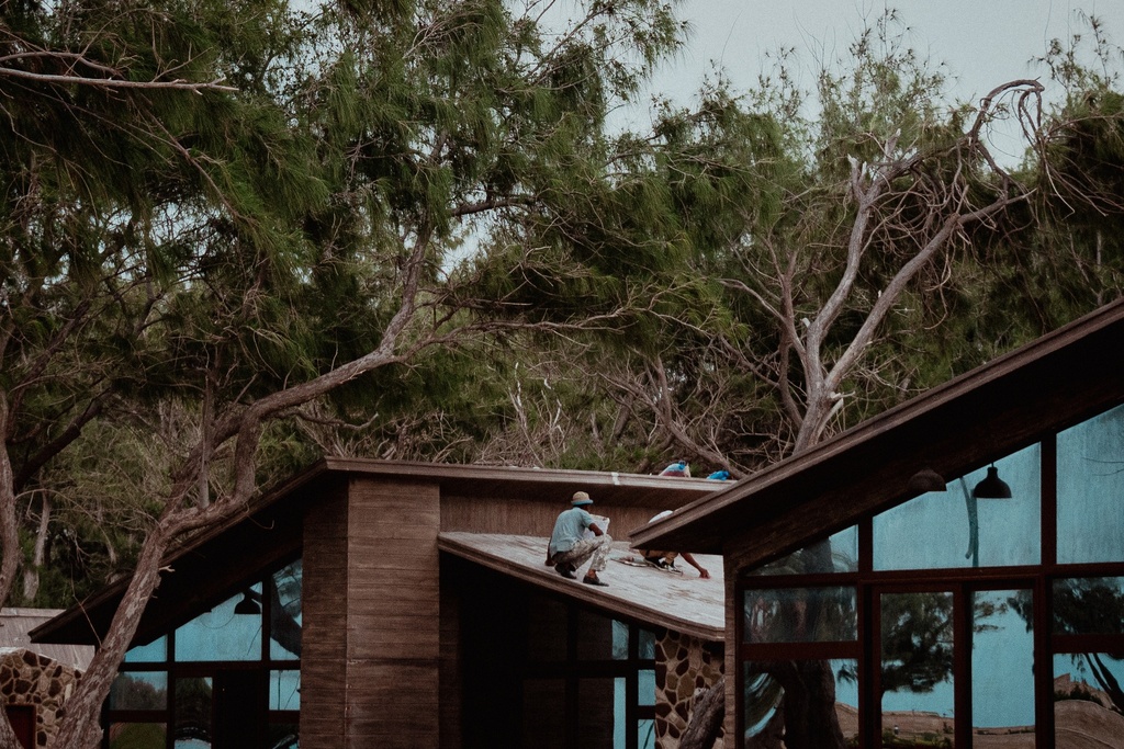 people working  on house roof stock images