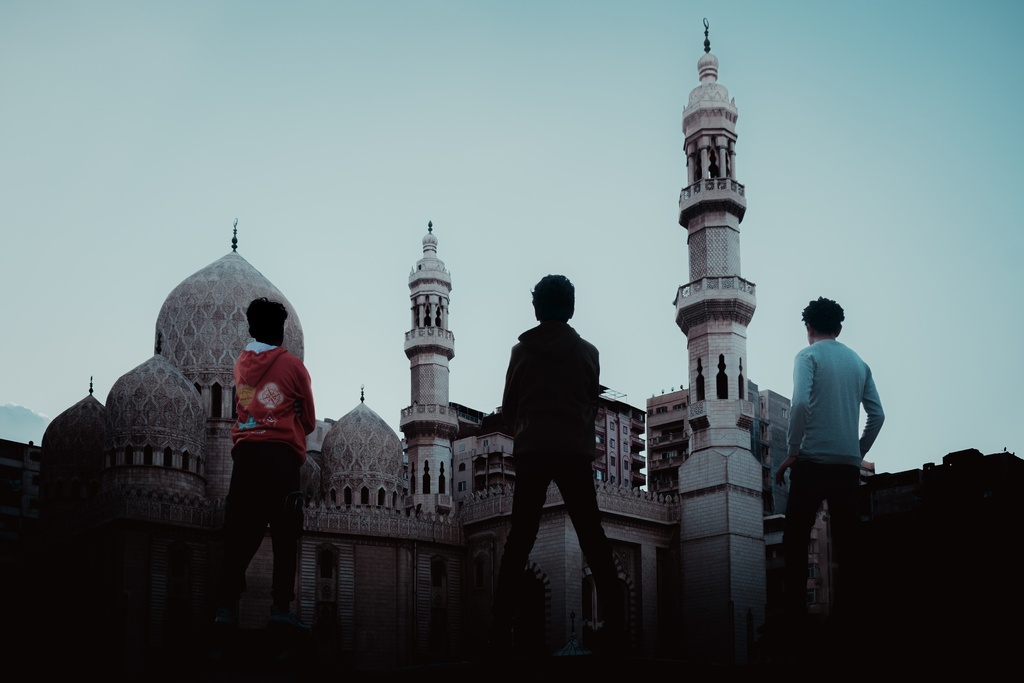 Three young men standing in front of Al-Marsa Abu Al-Abbas Mosque - stock image