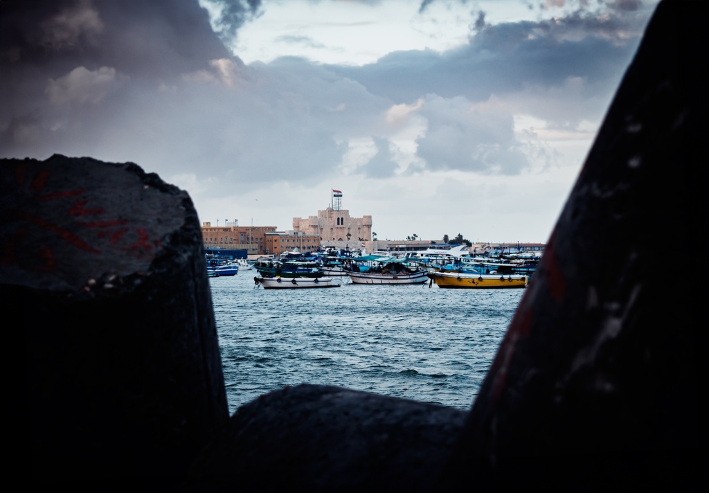 Qaitbay Citadel from behind the rocks - a distance photo - stock imagee