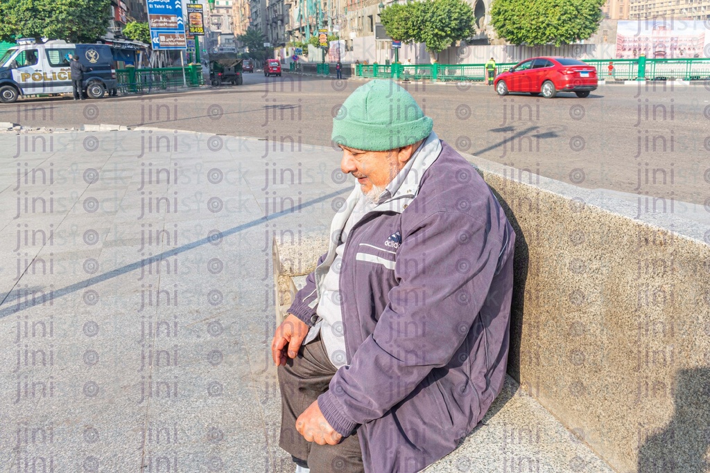 poor man on a bench in down town