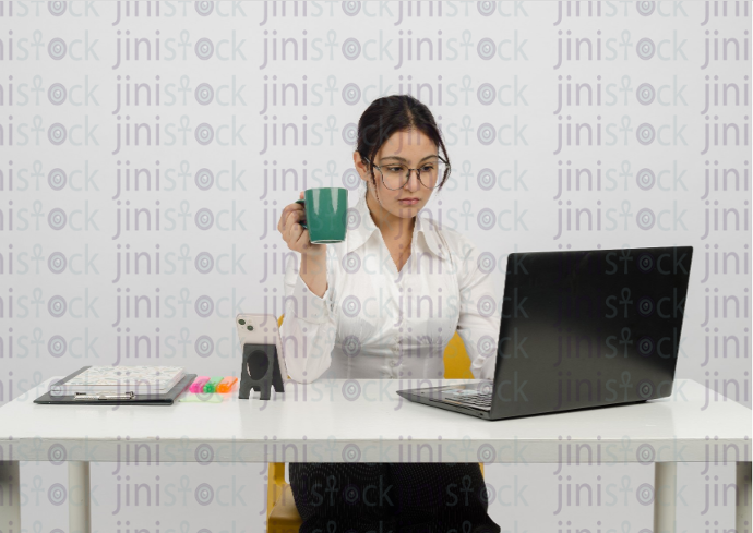 a sad woman working on a laptop - stoke image