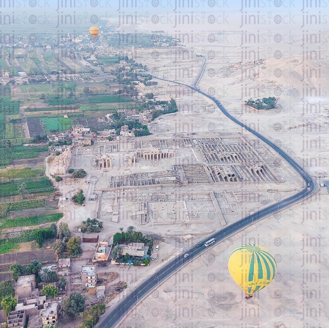 Air balloon in Luxor flying over a green field farming lands