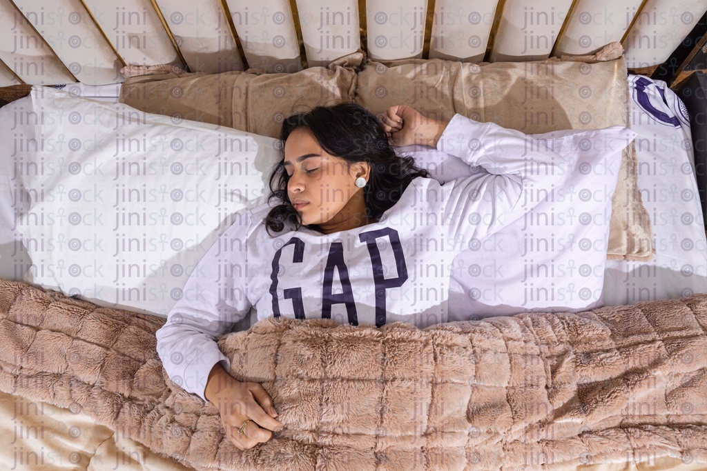 woman sleep in her bed top view