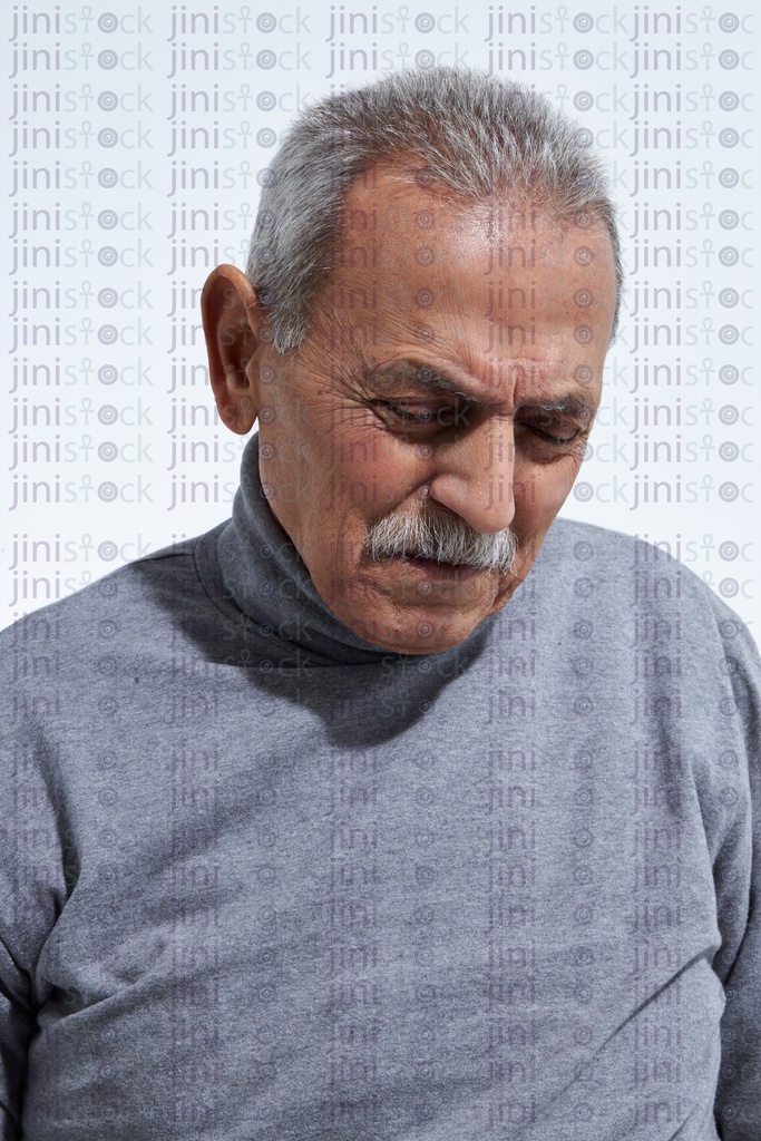 old man portrait with his hands over his eyes out of pain and sadness