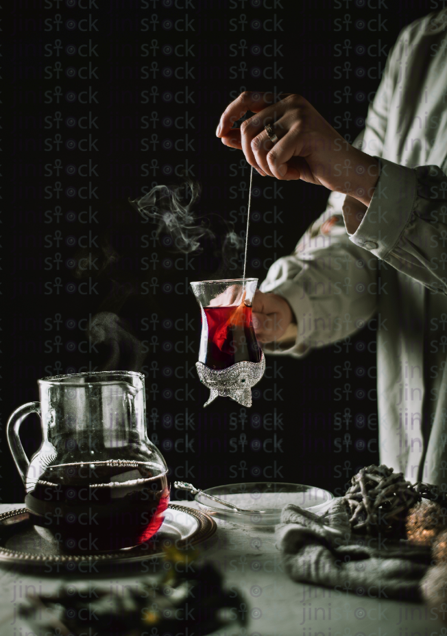 someone preparing Arabian tea with mint