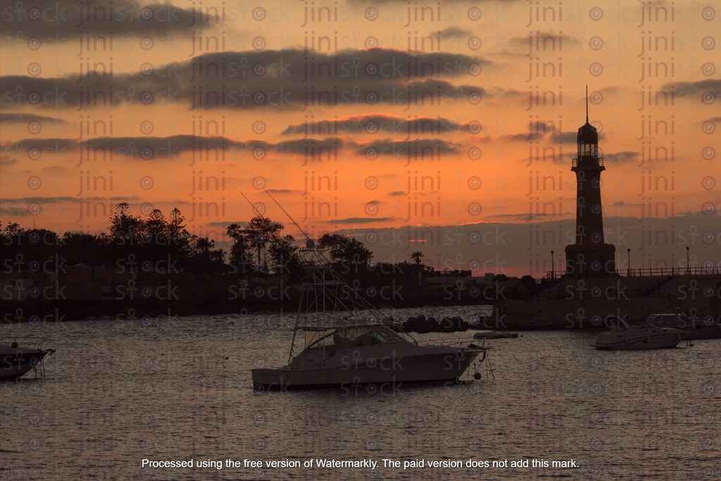 lighthouse Alexandria Egypt During sunset, a yacht on port