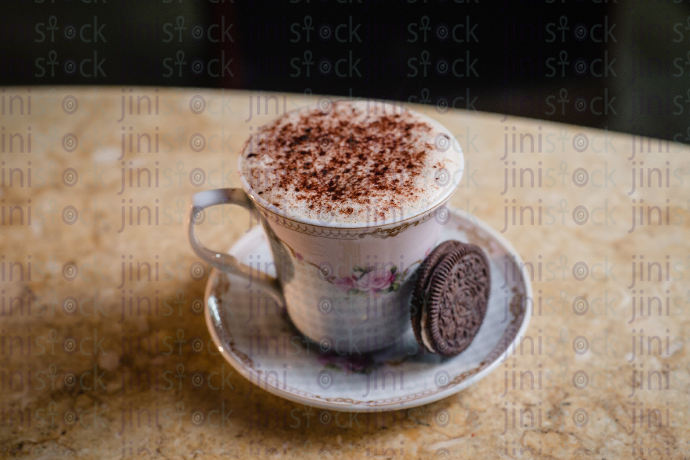 Cappuccino with white foam and Oreo on the side  stock image