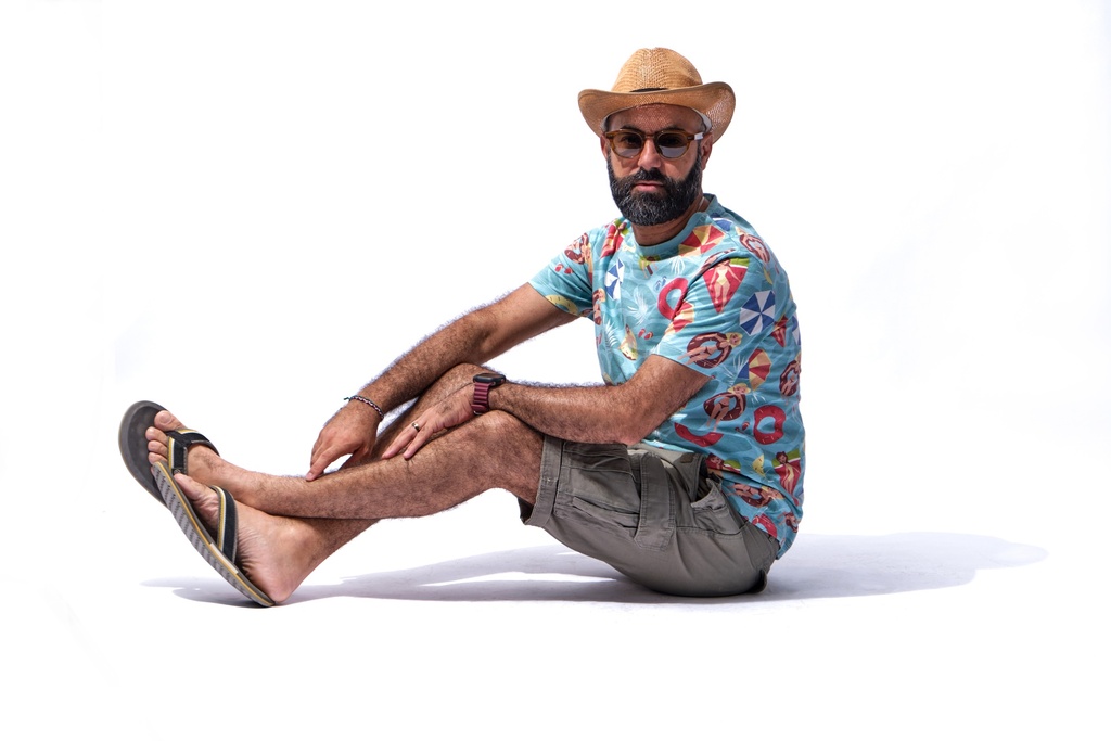 man in flip flop relaxing on the beach.