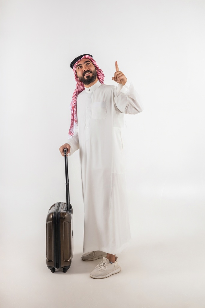 a man from gulf holding a traveling case and pointing up