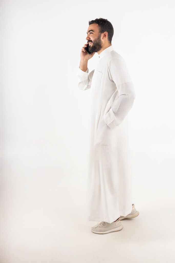 a khaliji man making a call stock image