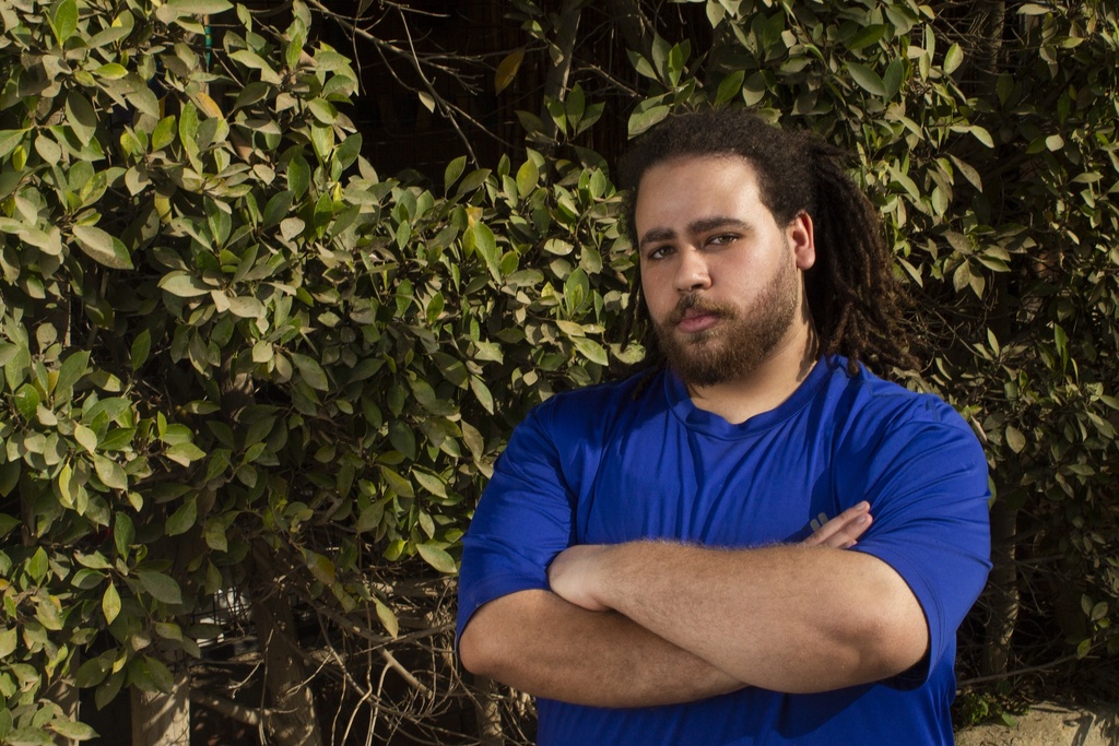 Man with rasta hair style standing confidently