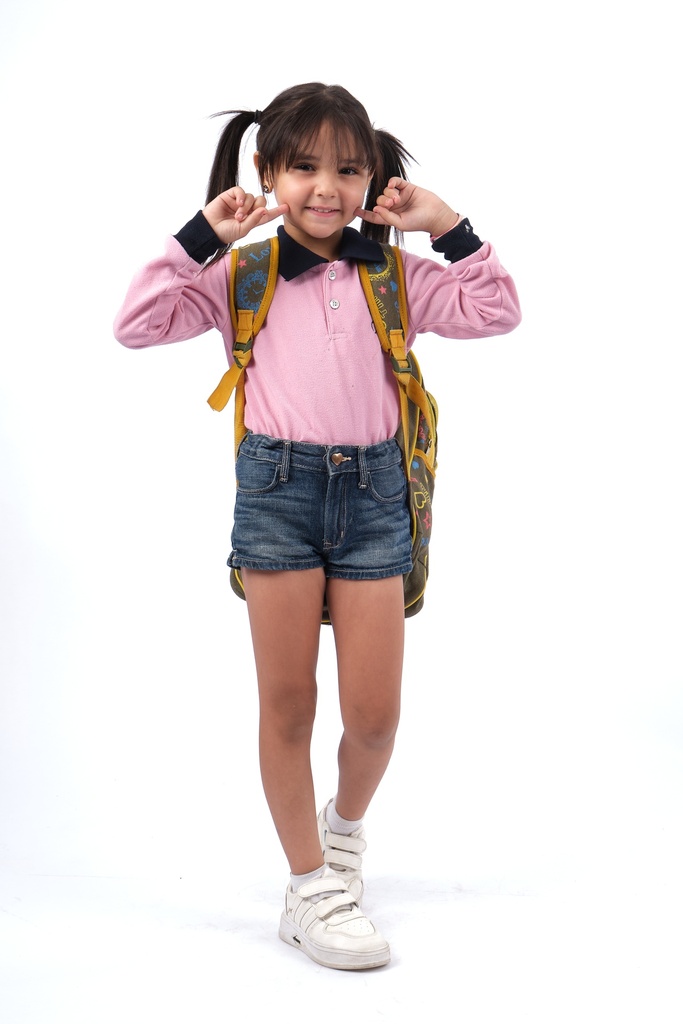 little girl in school uniform pointing to her smiling