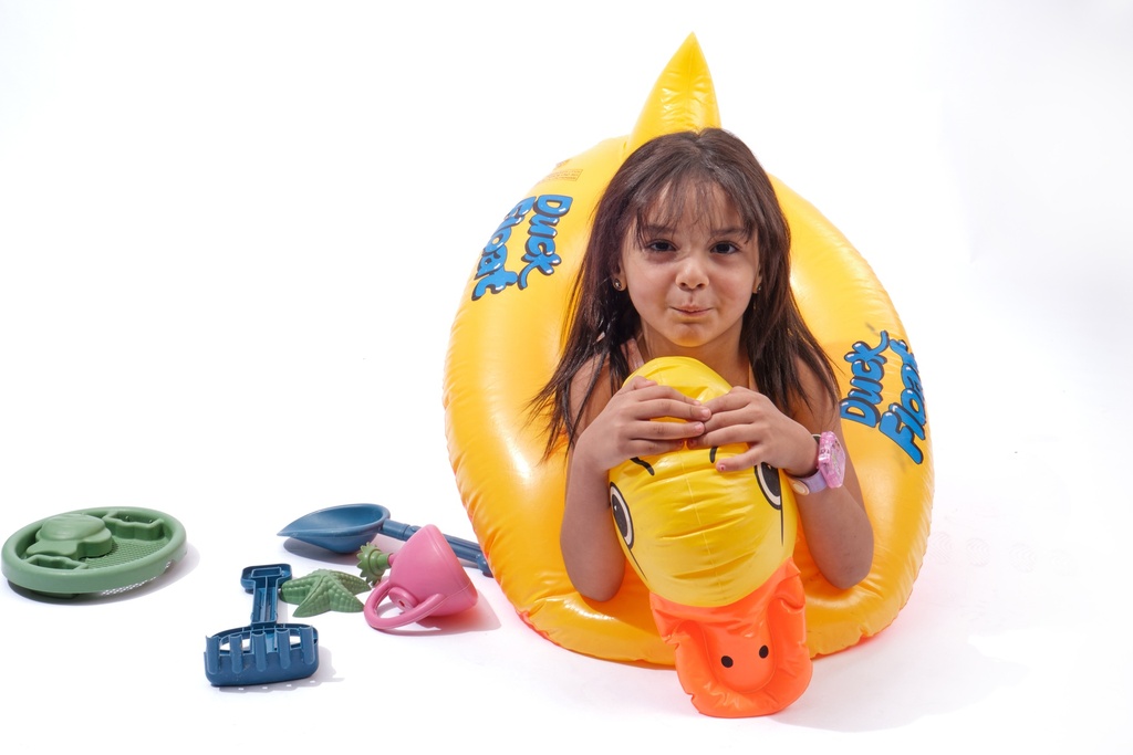 little girl swimming with duck water floater in a pool