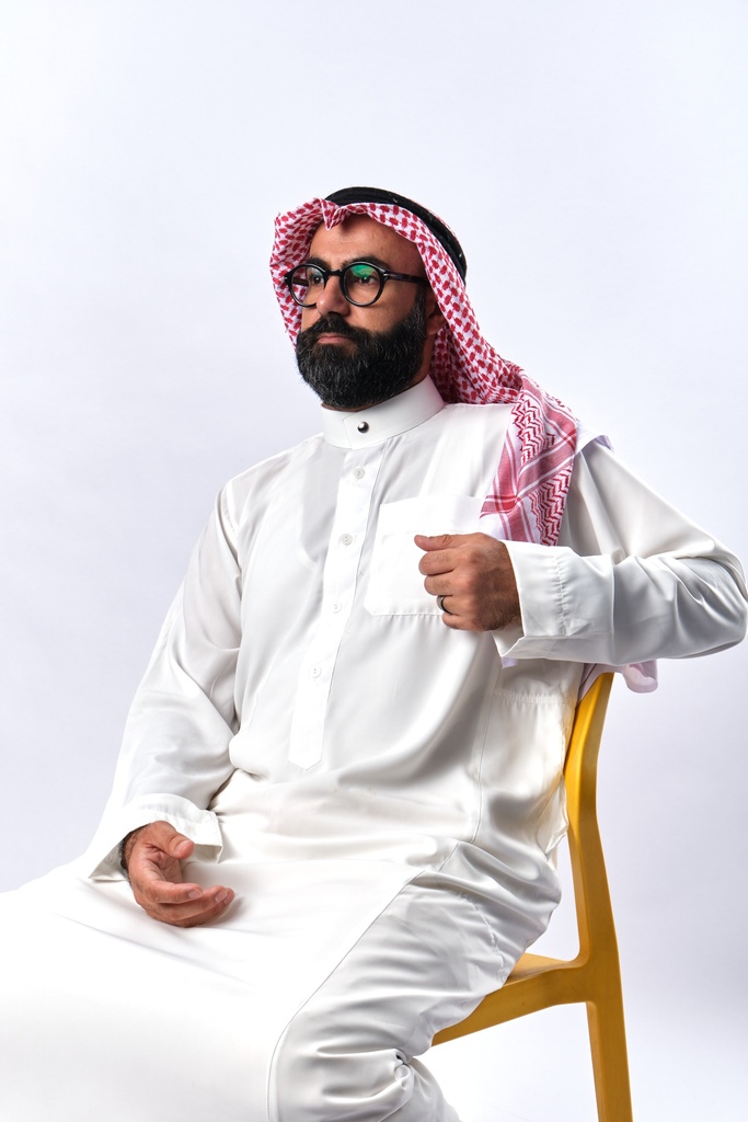 gulf Khaliji man setting on a chair