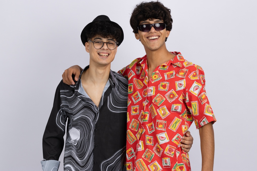 Two friends young men in summer outfit happy and looking to the camera