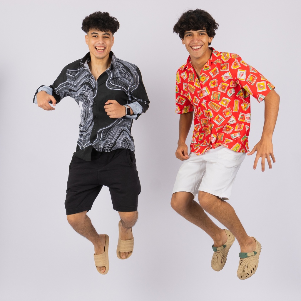 Two young men jumping in summer outfits