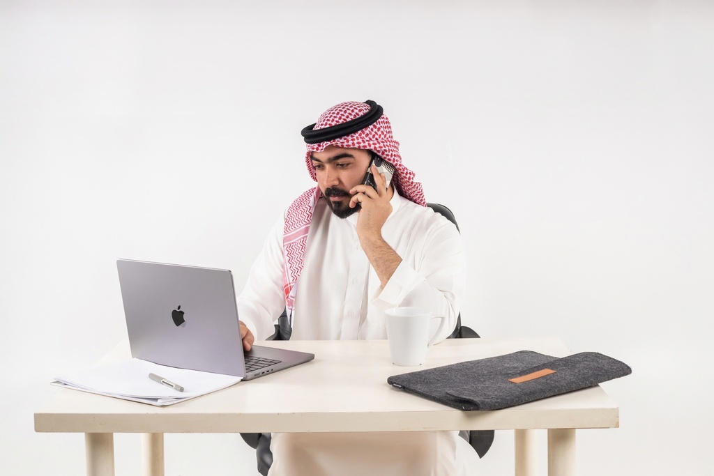 khaliji man working on laptop stock image