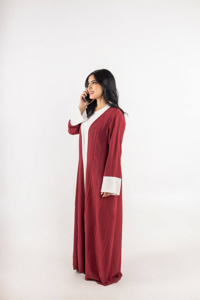 a khaliji woman wearing a long red dress and talking on the phone stock image