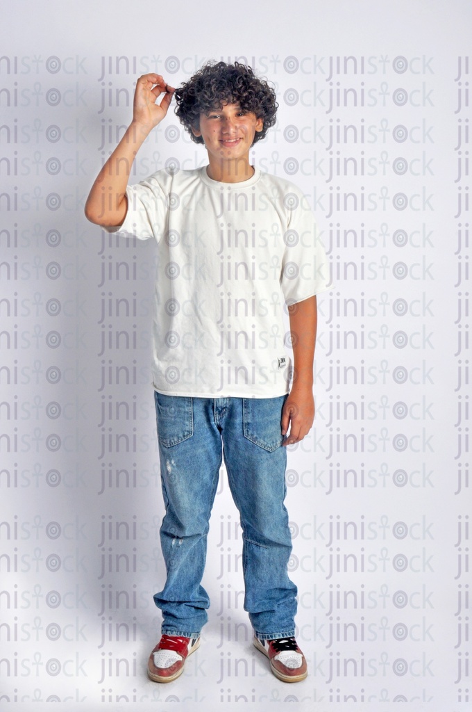A teen boy playing with his curly hair.