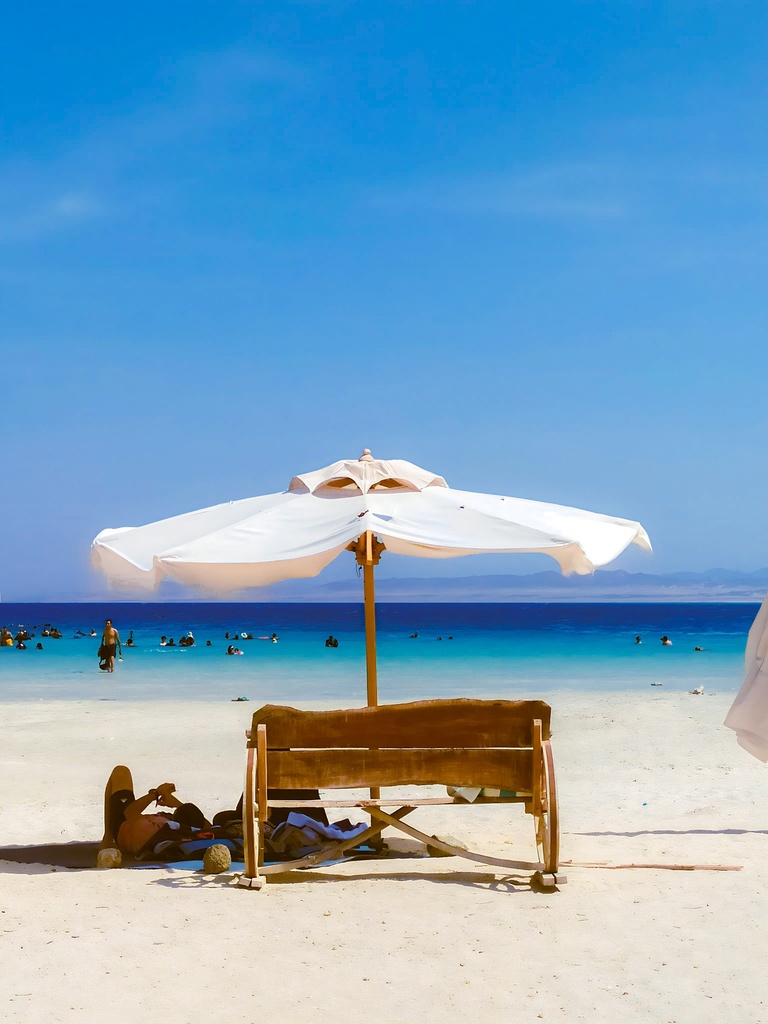 white beach umbrella on marsa alam beach