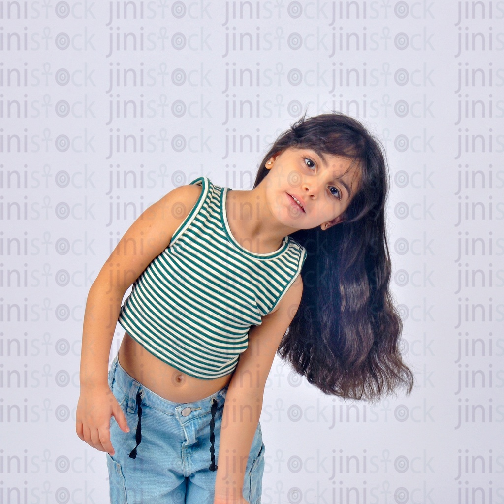 A child leaning towards one of her sides with her body and hair