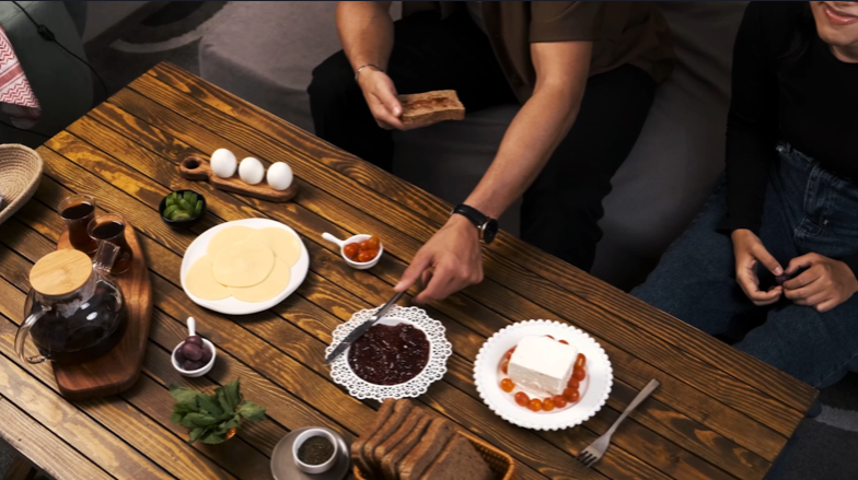 Top view for breakfast table while people eating jam