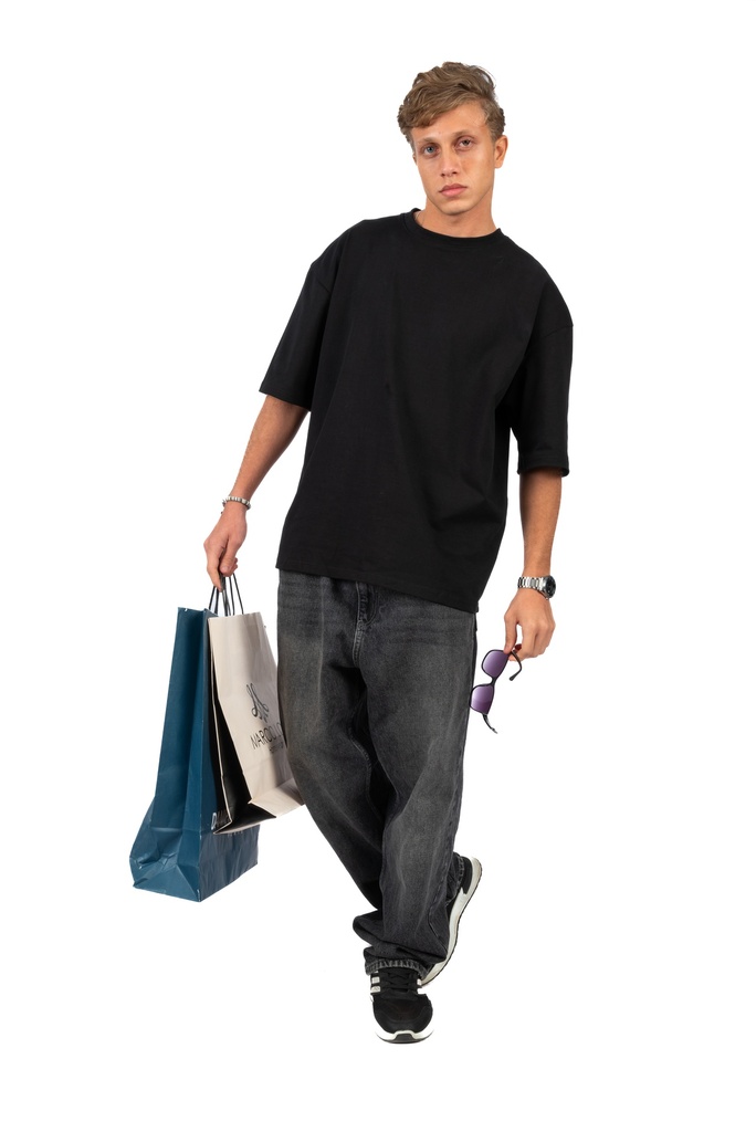 Egyptian male model posing with a shopping bag