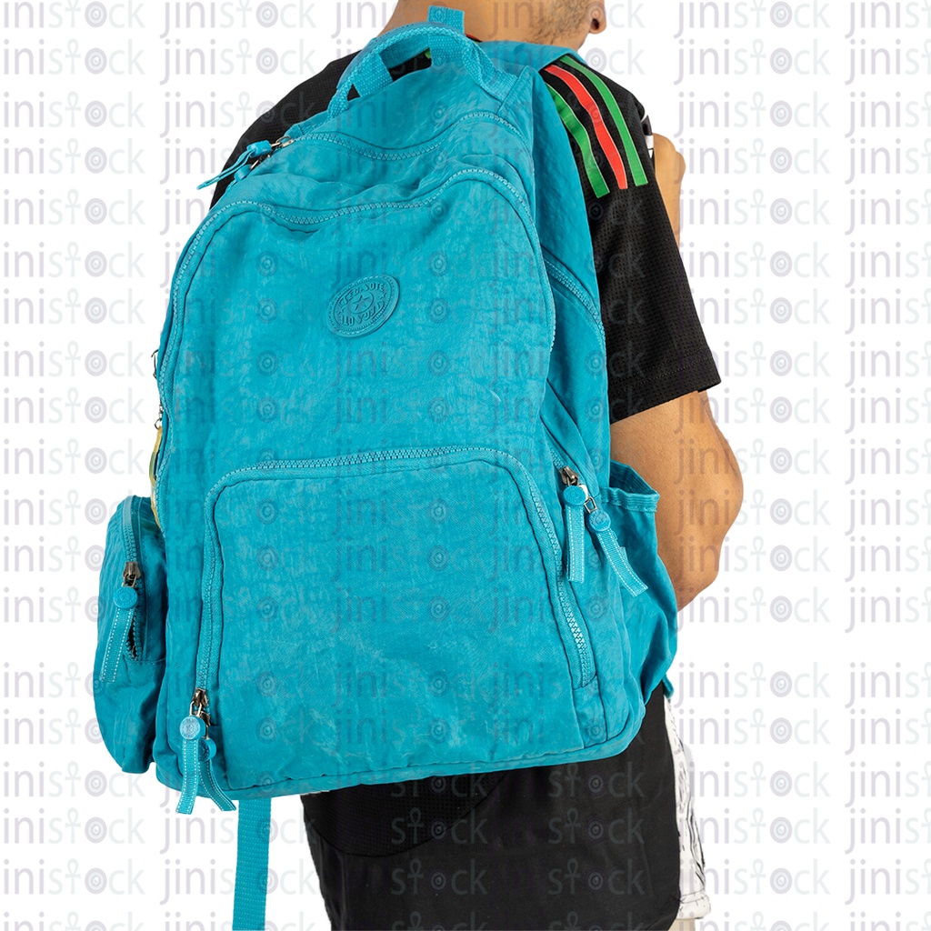 A boy carrying a turquoise bag