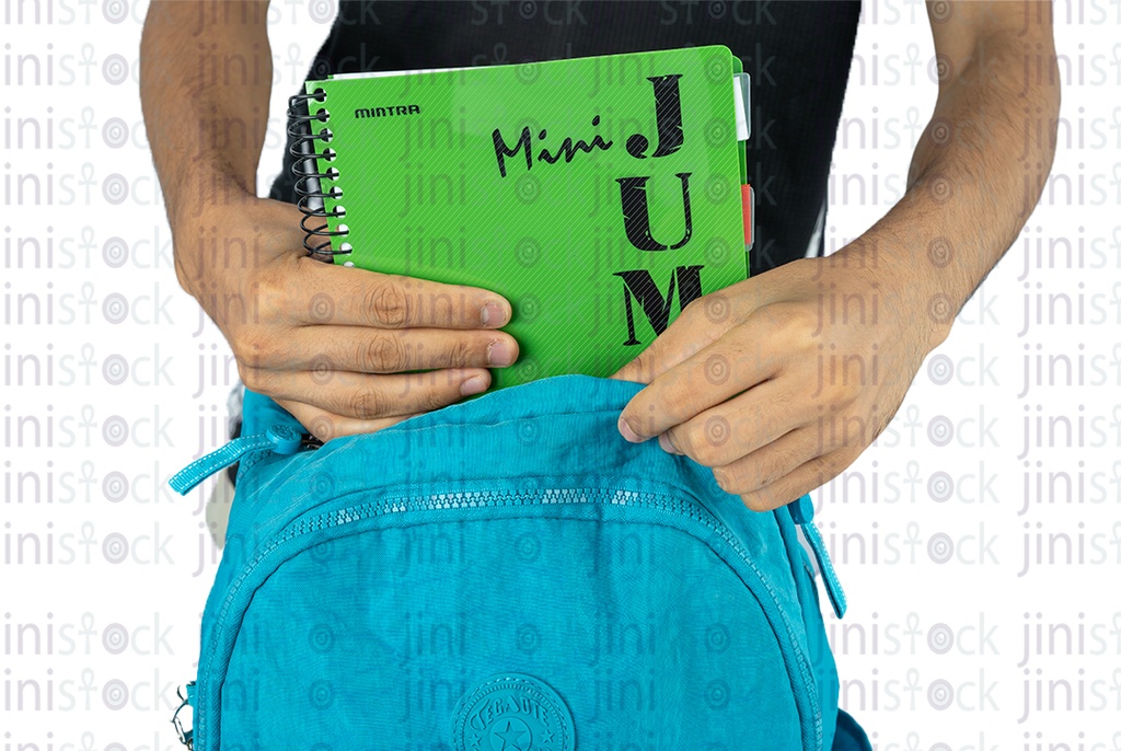 A boy puts a book in a turquoise bag