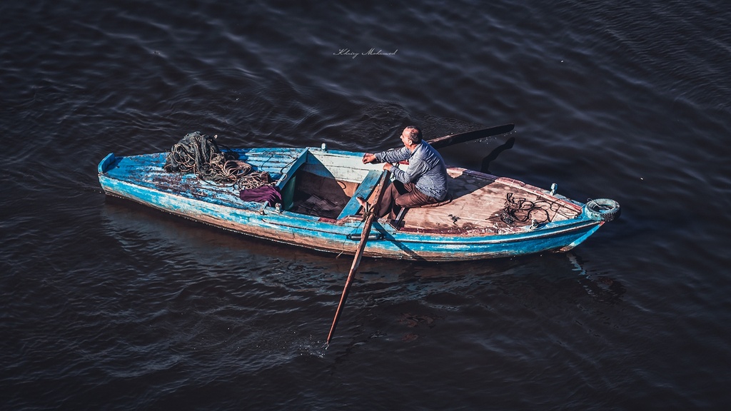 fisher Man sleeping in his fishing boat the In Nile