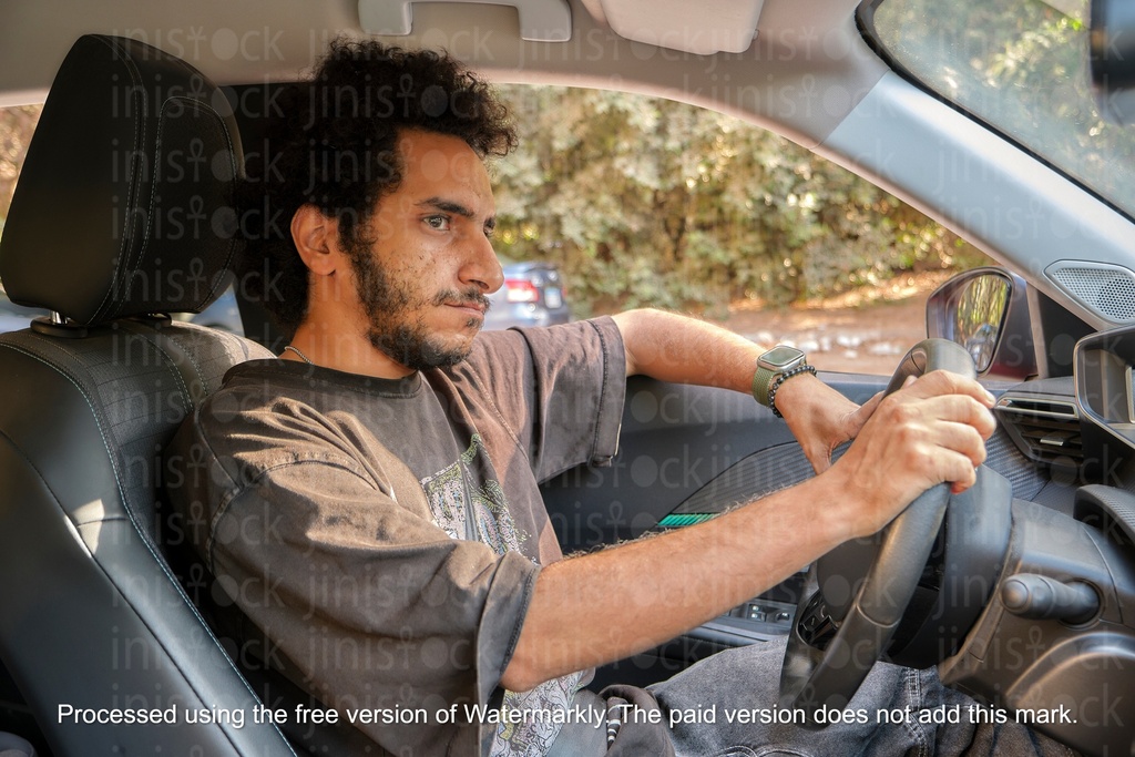 Man driving  with curly hair