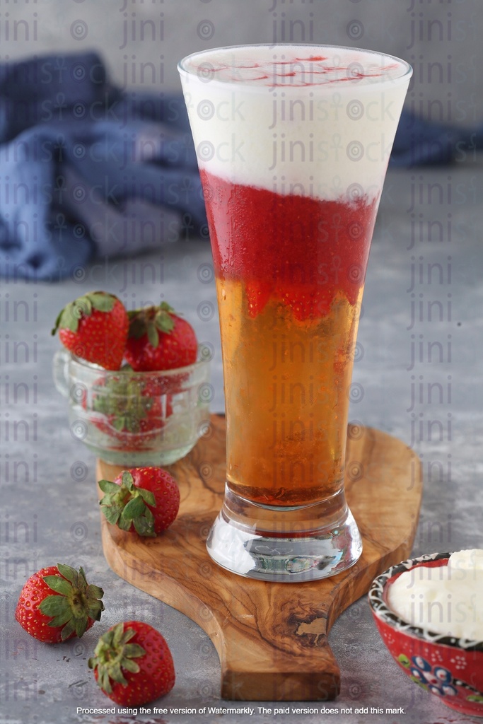 glass is filled with a refreshing blend of apple and strawberry juice