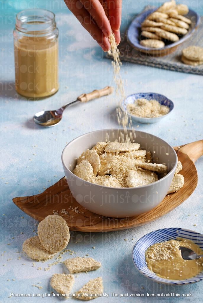 Adding sesame to a bowl of milk and biscuits