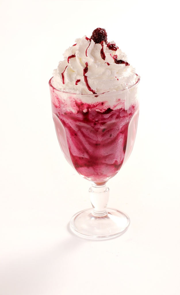 Raspberry milkshake topped with a cream