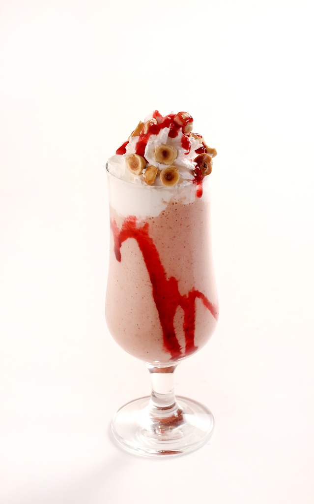 creamy strawberry milkshake topped with strawberry sauce whipped cream