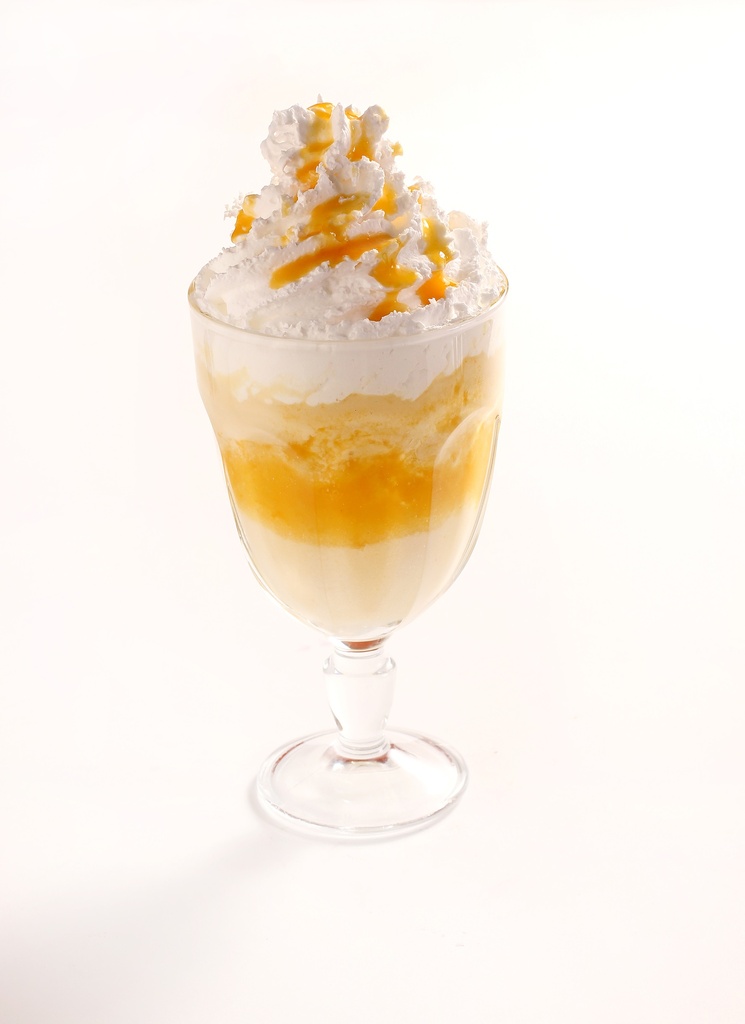 creamy mango milkshake topped with mango sauce whipped cream